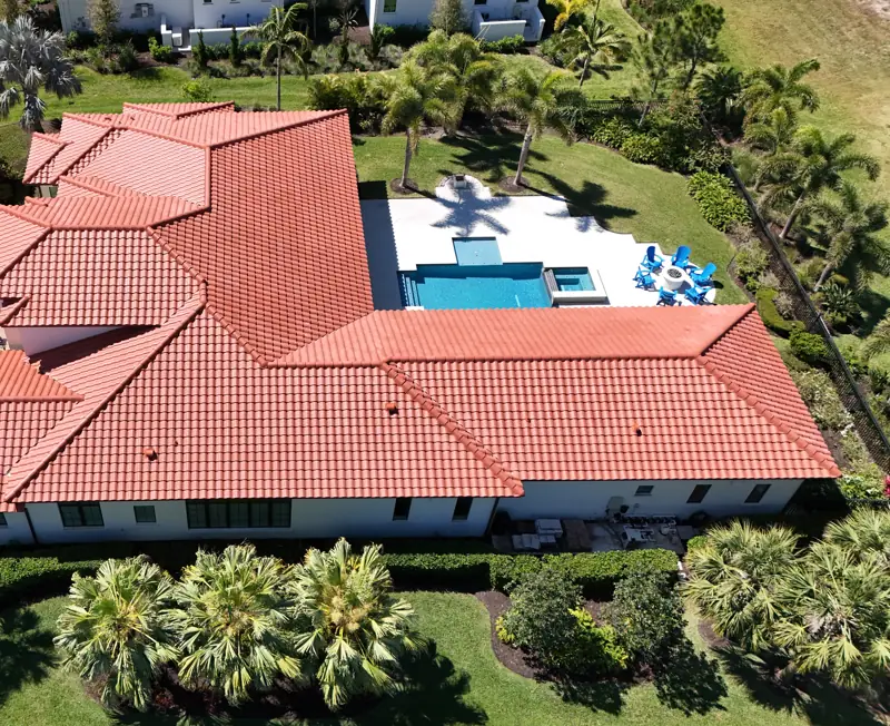 Aerial view of a new red concrete tile roof completed by Epoch Roofing in Sarasota, FL